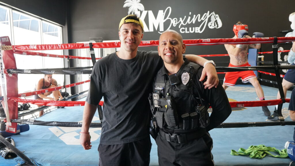 The owner Marcos, with a local police officer at a community event
